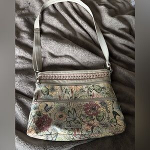 Sakroots Artist Circle crossbody bag featuring a floral and bee print
